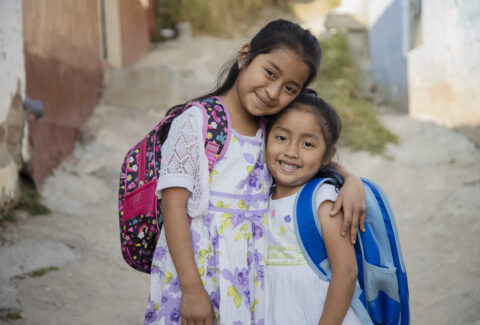 Hispanic girls ready to go to school in rural area - Latin sisters on their way to school - Happy Mayan girls in the village
