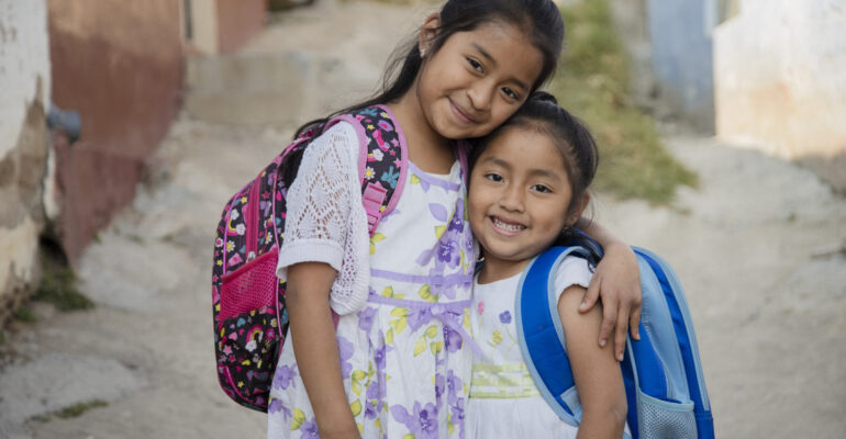 Hispanic girls ready to go to school in rural area - Latin sisters on their way to school - Happy Mayan girls in the village