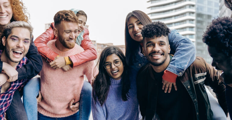 Diverse people having fun together outdoor in the city - Happy youth friendship - Focus on gay man face wearing makeup